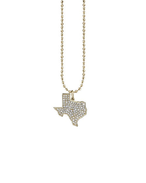 Gold necklace with diamond and gold Texas state charm.