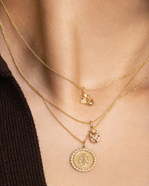 Model wearing Ladybug necklace with other Sydney Evan jewelry pieces. 