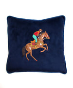 Navy colored cushion cover with embroidered cowboy riding horse. 