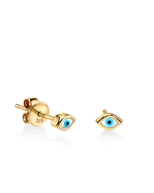 Gold stud earrings with Evil Eye design in front of white background.
