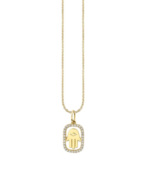 Gold necklace with gold and diamond hamse charm in front of white background. 