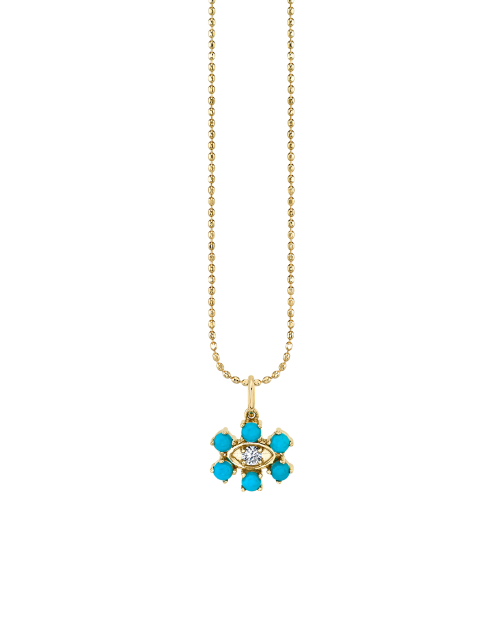 Gold necklace with gold and turquoise flower charm with eye in the middle. 