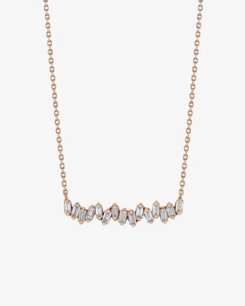 Rose gold necklace with baguette-cut diamonds in a slightly wavy line. 