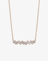 Rose gold necklace with baguette-cut diamonds in a slightly wavy line. 