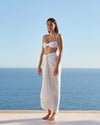 Model wearing Panneaux Cover-Up in Off White in front of ocean backdrop.