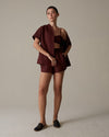 Model wearing Julia Shorts in front of tan/neutral backdrop. 