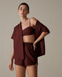 Model wearing Blouse with matching colored top and shorts.