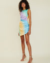 Model wearing sparkling, vibrant, ombre mini dress in front of white background. 