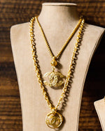 Coco Mark Necklace on jewelry mannequin.