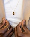 Man wearing Small Dog Tag Pendant Necklace with tan suit jacket and white tee. 