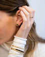 Model wearing Shimmer Stud Earrings with matching ring and bracelets.