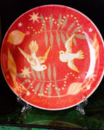 Red plate with turtle doves surrounded by Christmas ornaments and "Turtle Doves" at bottom in cursive.