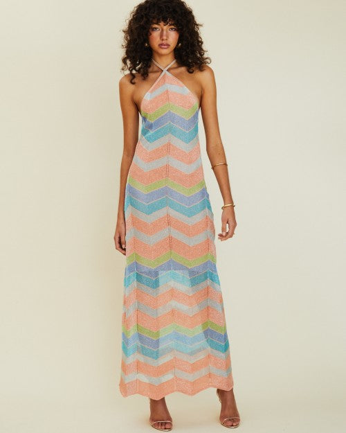Model wearing Solar Chevron Halter Maxi Dress in front of a white background. 