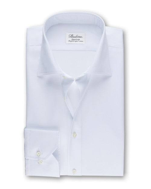 An overhead view of a folded white button-down shirt with a chest pocket including two buttons. The shirt has a white square label inside the collar that reads "Stenströms" in cursive. The background is white.