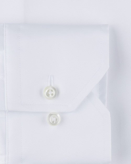 White fabric including a pocket with two clear buttons. 