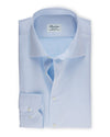 Fitted Body Light Twill Shirt in light blue folded in front of white background. 