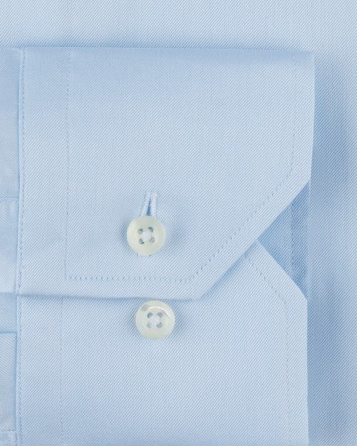 Light-blue fabric including a pocket with two clear buttons. 