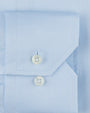 Light-blue fabric including a pocket with two clear buttons. 
