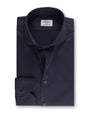 An overhead view of a folded navy button-down shirt with a chest pocket including two buttons. The shirt has a white square label inside the collar that reads "Stenströms" in cursive. The background is white.