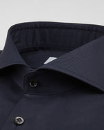 Close up of shirt collar and buttons.
