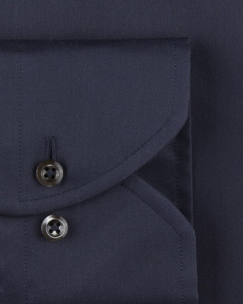 Navy fabric including a pocket with two black buttons. 