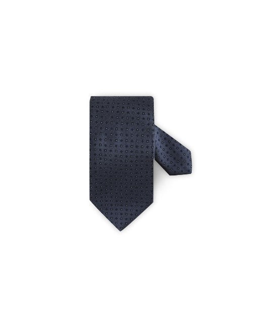 Patterned Silk Tie in blue in front of white background. 