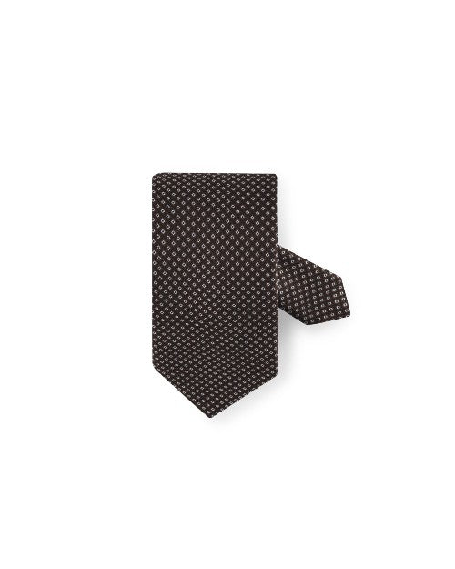 Patterned Silk Tie in brown in front of white background.