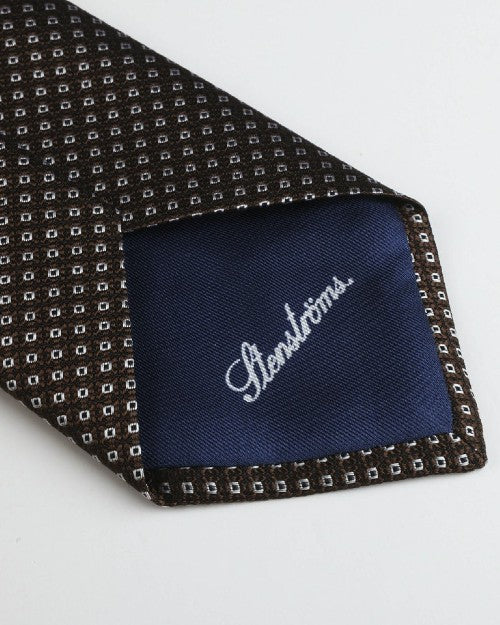 Close up of Strenstroms branding in white cursive on the tip of the tie. 