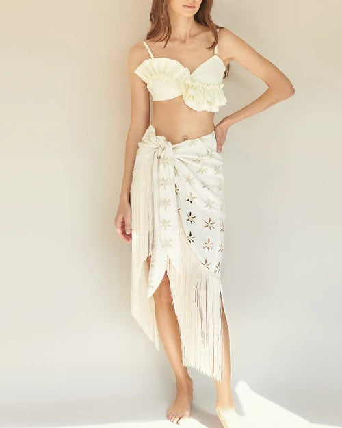 Model wearing ivory Lirios Cover-Up with floral designs cut out of the fabric.