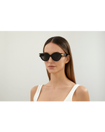 Model wearing Unapologetic Woman Sunglasses in front of white background.