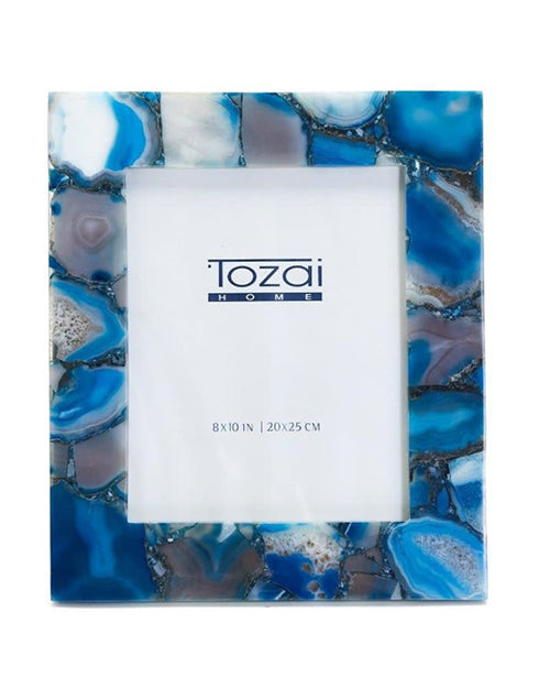 Vibrant blue agate photo frame in front of white background.