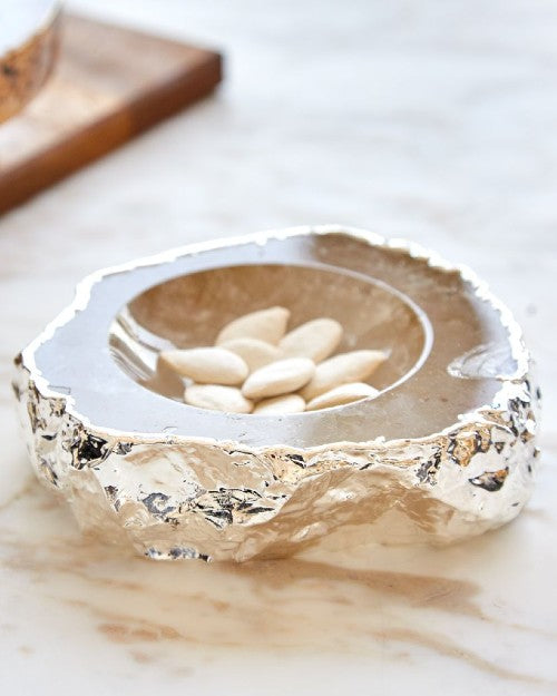 Crystal bowl with 24K gold exterior on marble table.
