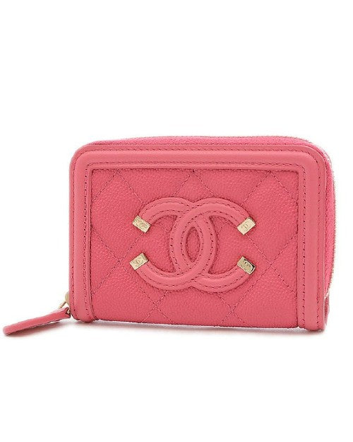 Vibrant pink quilted coin case with Chanel logo and gold accents.