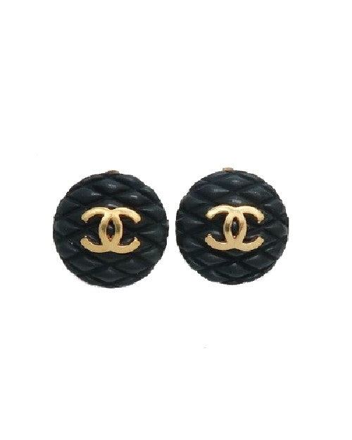 Black quilt earrings with gold Chanel logo on top.