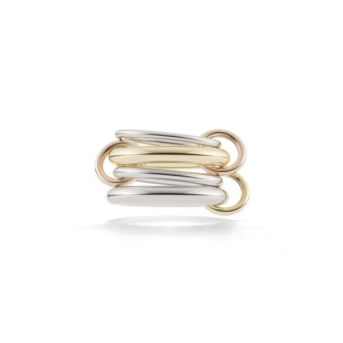 Silver, gold, and rosegold rings stacked on top of each other. 