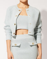 Model wearing The Carly Cropped Cardigan in Powder Blue with matching skirt and top.