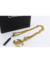 Coco Mark Necklace on white table beside black Chanel bag.