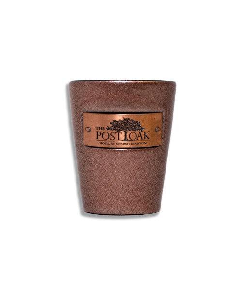 The Post Oak Copper Emblem Shot Glass in front of white background. 