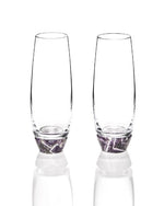 2 champagne glasses with amethyst at the bottom.