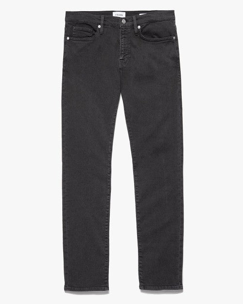 L'Homme Slim Fit Stretch Twill Jeans in a faded black color in front of a white background. 