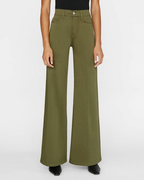 Model wearing Le Palazzo Pant in Surplus Green with black shirt and boots. 