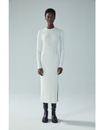 Model wearing Ribbed Sweater Dress in Off White in front of white background.