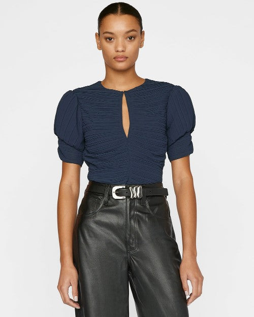 Model wearing Ruched Sleeve Keyhole Top in navy with black leather pants. 