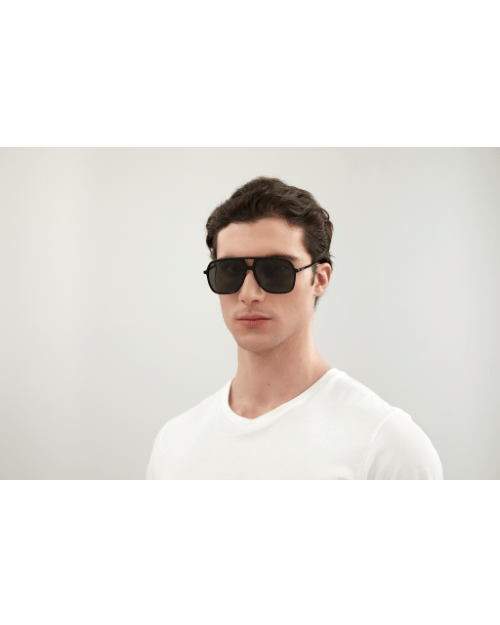Model wearing Gucci Logo Man Sunglasses in front of white background.