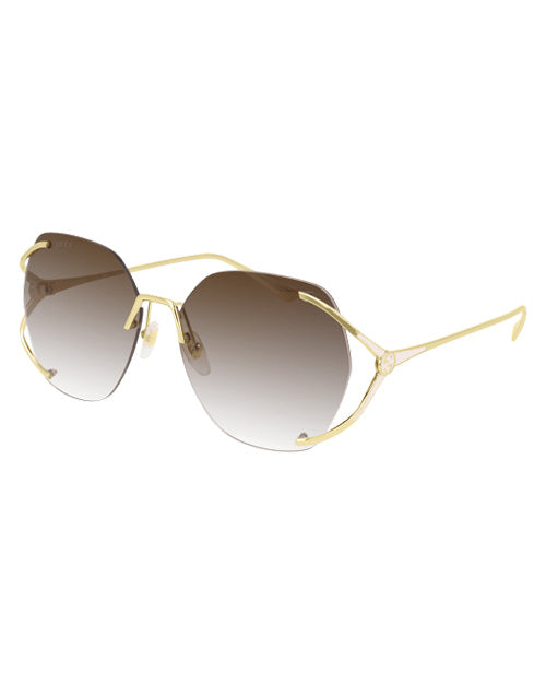 Gucci Logo Woman Sunglasses in gold in front of white background.