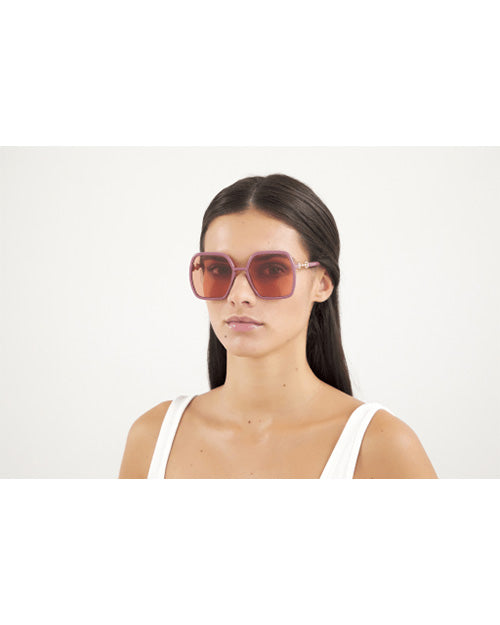 Brunette model wearing Pink Gucci Horsebit Woman Sunglasses.