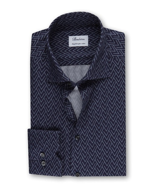 An overhead view of a folded navy button-down shirt featuring a grey arrowlike triangular design and a chest pocket with two buttons. The shirt has a white square label inside the collar that reads "Stenströms" and 'Crafted to perfection.