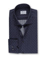 An overhead view of a folded navy button-down shirt featuring a grey arrowlike triangular design and a chest pocket with two buttons. The shirt has a white square label inside the collar that reads "Stenströms" and 'Crafted to perfection.