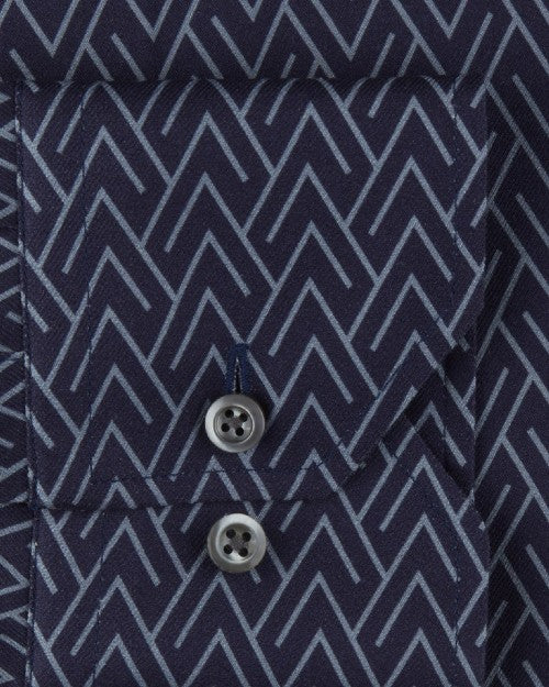 Fabric with a grey arrowlike triangular pattern, and a pocket with two black buttons. 