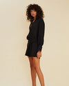 Side view of Halley Oversized Mini Shirt Dress in black, showing belt. with resin 'O' belt.